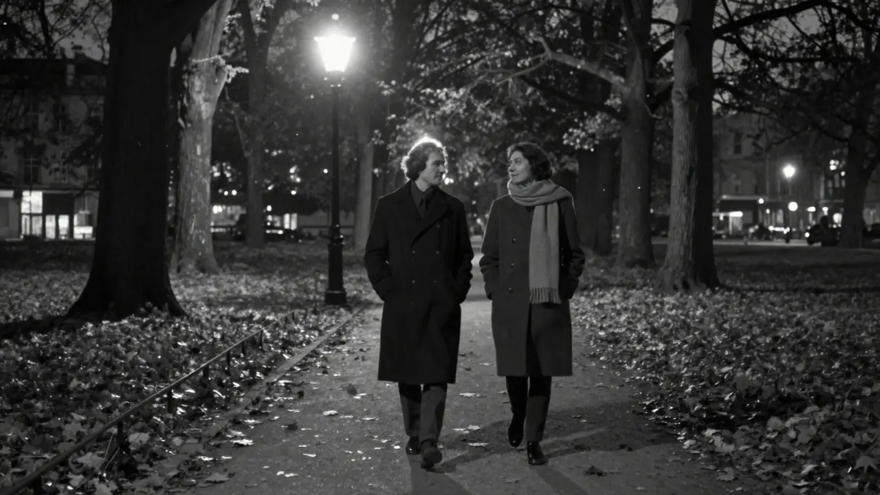 Two figures walk silently through Tiergarten park at night, autumn leaves falling around them in soft focus.